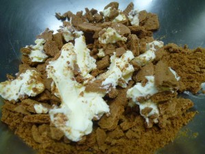 Soft butter mixes into the cookie crumbs with a lot of messy, sticky hand action!  Mix these into your other crumbs and load on top of the fruit in the baking pan
